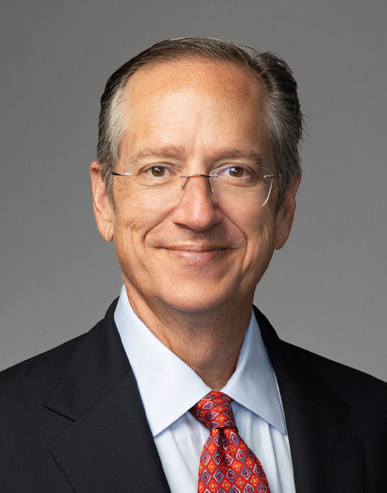 Lewis Johnson, in a dark suit with a light blue shirt, is working as a Chief Investment Officer at Capital Wealth Advisors