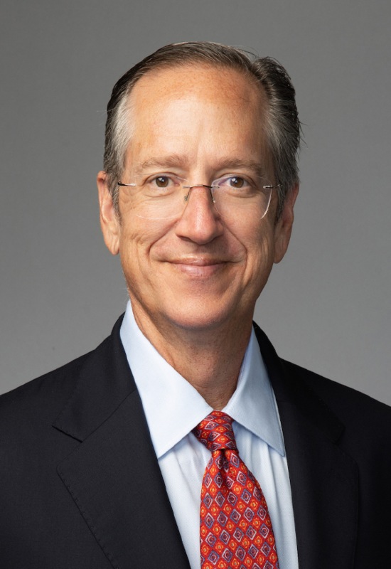 Lewis Johnson, in a dark suit with a light blue shirt, is working as a Chief Investment Officer at Capital Wealth Advisors